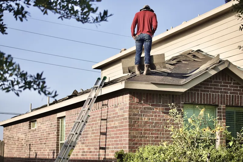 Professional roofer working on a residential roof in Pleasant Plains
